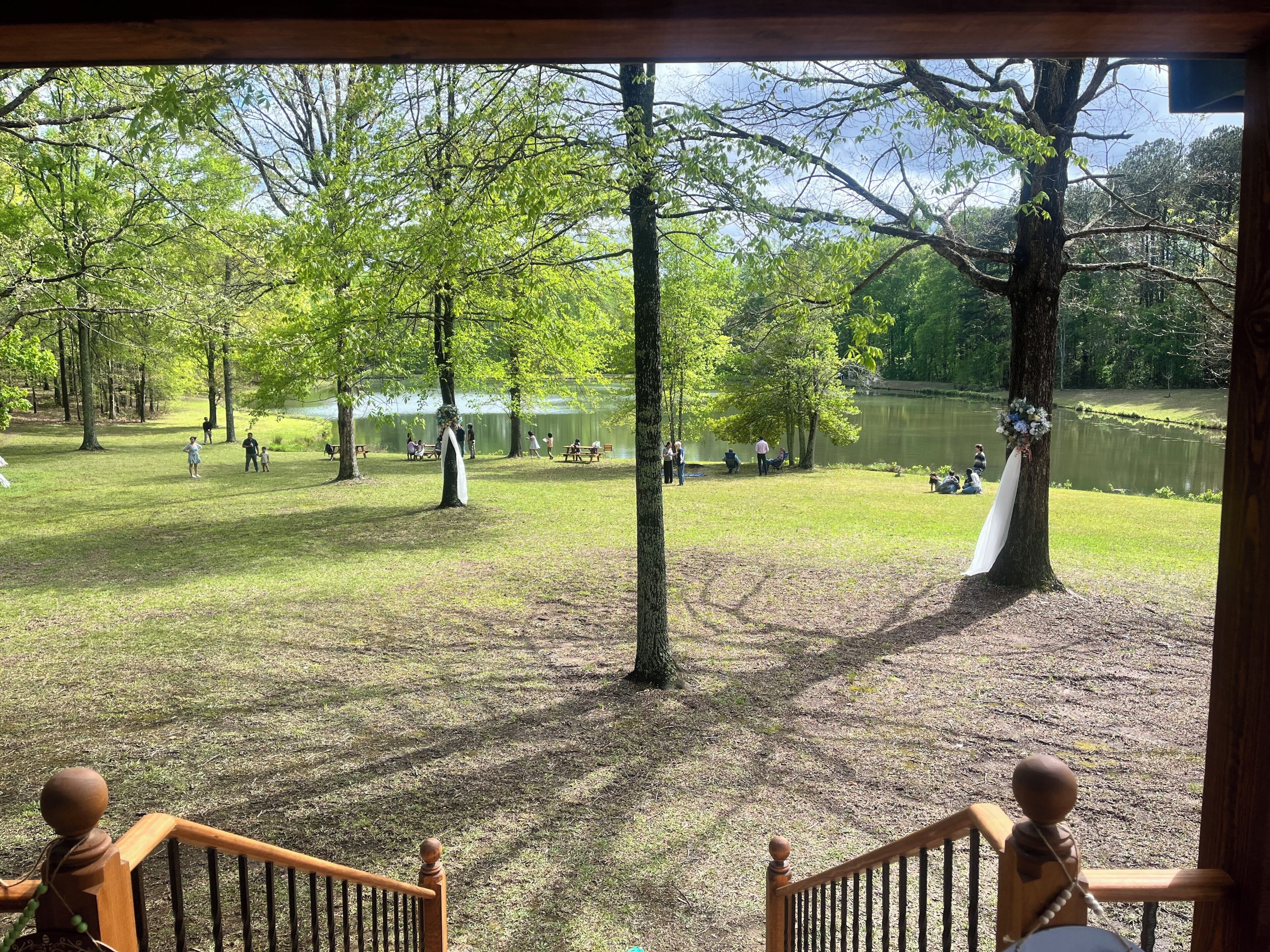 A park with picnic tables and people.