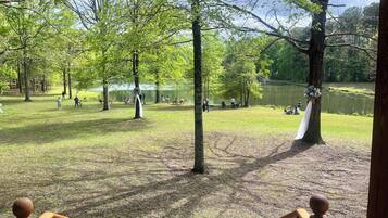A park with picnic tables and people.