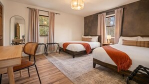 A hotel room with two beds, a wooden desk, a chair, a mirror, and a window with curtains. - New River Gorge - Private Acre, Pet-Friendly, Dome, Hot Tub, Sauna, Firepit (Oak Hill)