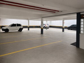 A parking garage with multiple levels and cars parked.