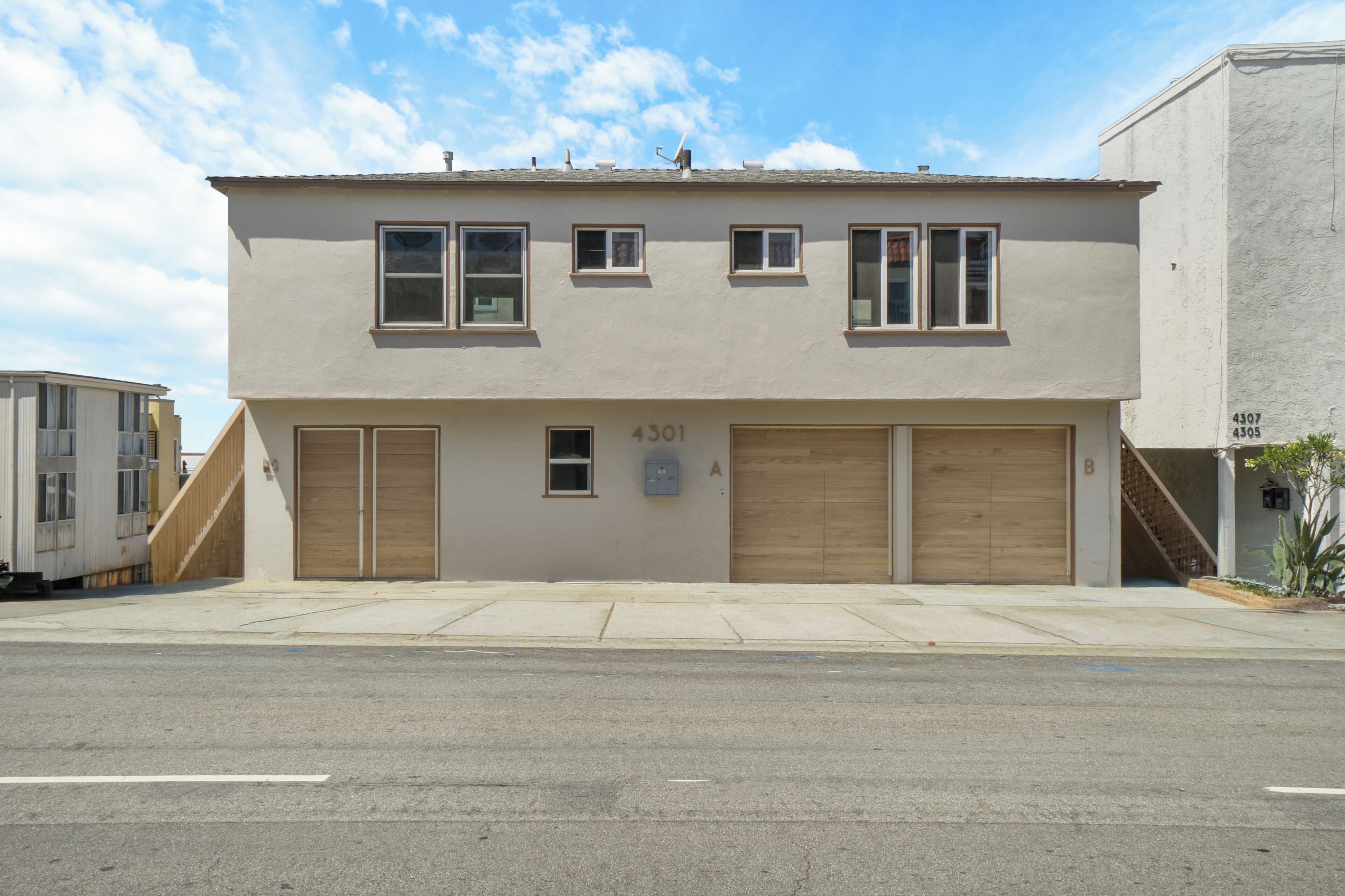 A two-story building with a garage, numbered 4301, and a small window.