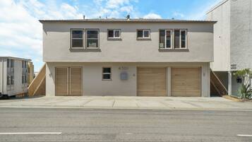 A two-story building with a garage, numbered 4301, and a small window.