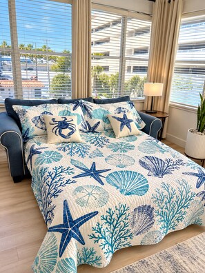 A bedroom with a bed, a nightstand, a lamp, and a window with curtains. - Premium Oversized Vacation Condo! Steps to the Broadwalk & Beach.
Game Lounge. (Hollywood)