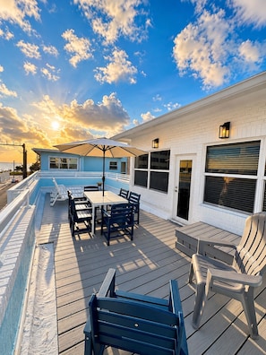 A deck with a table and chairs, a pool, and a building with a garage. - Premium Oversized Vacation Condo! Steps to the Broadwalk & Beach.
Game Lounge. (Hollywood)