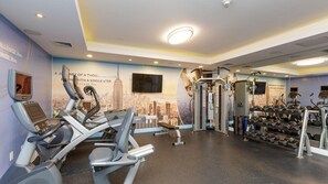 A gym with treadmills, weight machines, and dumbbells. - NYC Stay Near Times Square, Broadway & Dining with King Guest Room Comfort (New York)