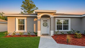 A single-story house with a front entrance, two windows, and a small porch. - ‼️Citrus Springs 3BR - Gulf & Springs 30 Min (Citrus Springs)