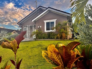 A two-story house with a well-maintained lawn and various plants. - Royal Palm Luxury Villa (Ocho Rios)