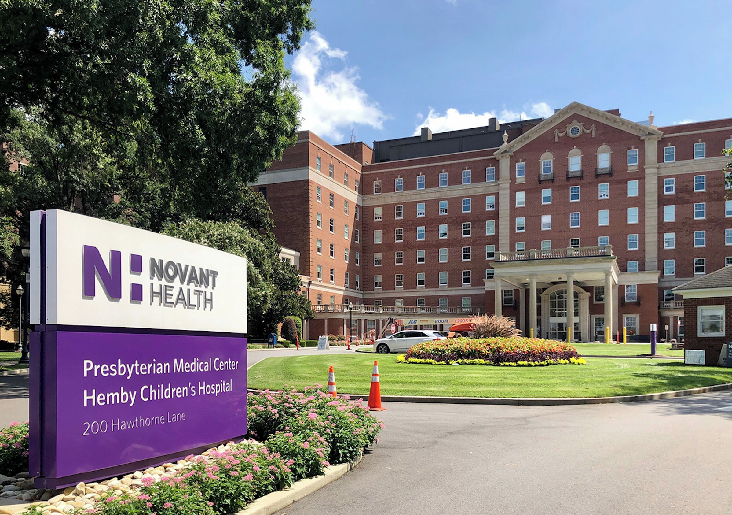 A hospital sign with 'Novant Health' and addresses for Presbyterian Medical Center and Hemy Children's Hospital.