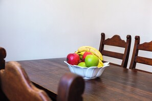 A wooden dining table with a bowl of fruit. - Luxury 2BR apartment Marrakech (Marrakesh)
