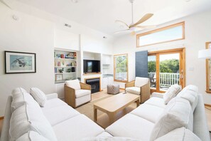 A living room with a sofa set, a coffee table, a TV, and a fireplace. - Walk to Beach w/ Private Pool in the Heart of Duck (Duck)