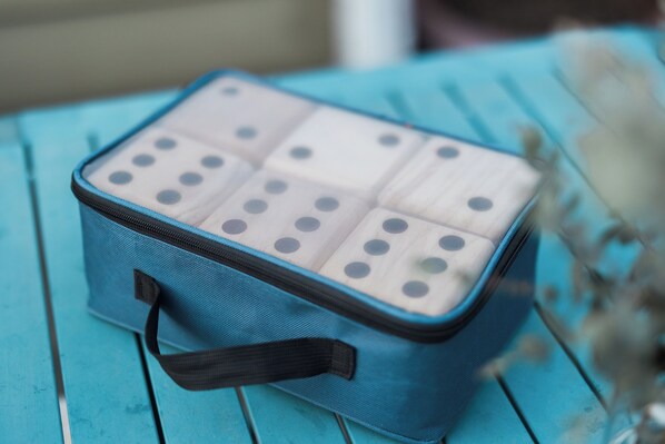 A blue bag with a zipper and a handle on a wooden surface. - Green Lake Craftsman - Family Zoo Passes - Dog Friendly (Seattle)