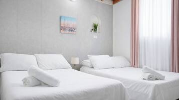 Tabla de planchar con plancha, internet y ropa de cama