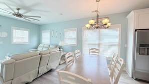 A dining area with a table and chairs, a ceiling fan, and a chandelier. - Luxury private House + Pool. Walk to the beach (North Myrtle Beach)