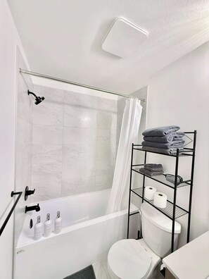 Shower, hair dryer, towels, shampoo