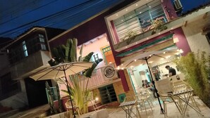 A hotel with a modern facade, outdoor seating area, and a visible entrance. - hotel boutique casa vecchia  (Cali)