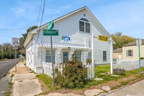 A white building with a porch, a speed limit sign, and a no parking sign. - Mermaid Hideaway | Quaint & Affordable Tropical Getaway! (Cheriton)