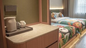 A hotel room with a kitchenette, a bed with colorful bedding, a bedside table, and a window with curtains. - Cloud View Wild Hotel (Xianyang)