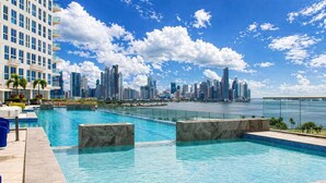 Una piscina con el horizonte de una ciudad al fondo.