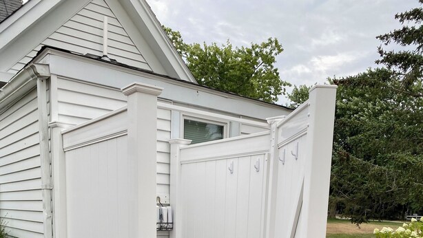 A white outdoor structure with a wooden platform and a door. - A quintessential Cape Cod family home in Dennis Port (Dennis)