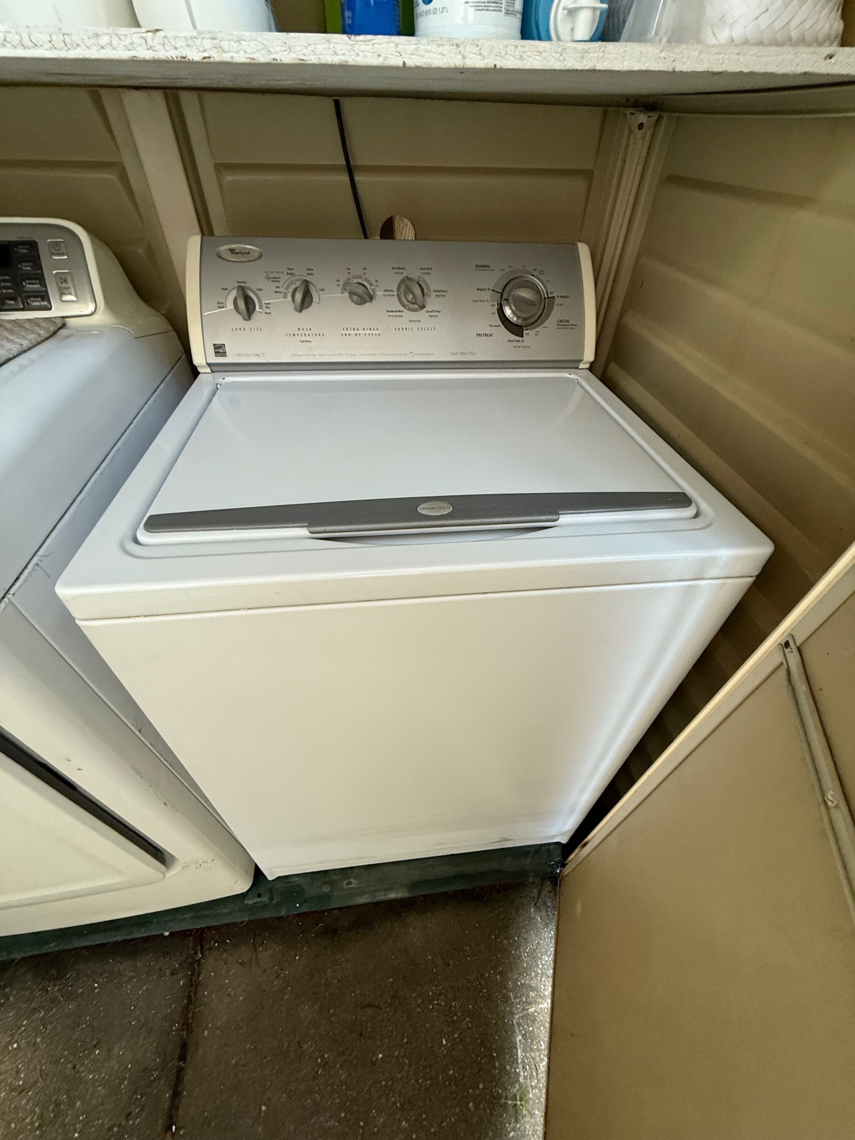 A compact washer and dryer unit with control knobs and a small digital display.