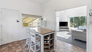 A room with a dining table, chairs, a TV, and a sofa. - Spacious Stay in New Norfolk (New Norfolk)