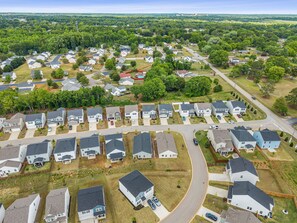 A residential area with houses, roads, and greenery.