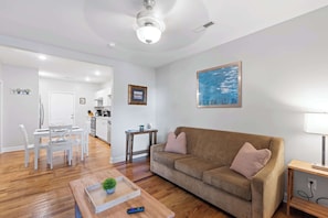 A modern living room with a sofa, coffee table, and dining area. - Minutes to the Zoo & Downtown! - McCallie Dugout (Chattanooga)
