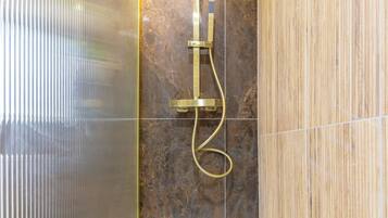 Shower, hair dryer, towels, shampoo