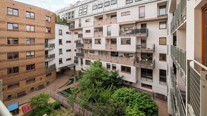 A multi-story residential building with balconies, a courtyard, and a playground. - Park Praski Homely Apartment (Warszawa)