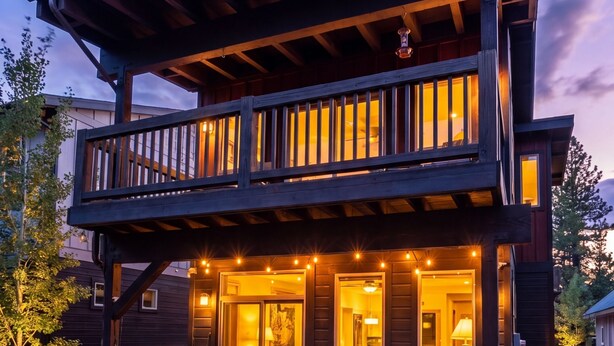 A two-story wooden house with a covered patio, outdoor seating, and a fire pit. - The Timberline Haus - Where Pines Meet The Payette (McCall)