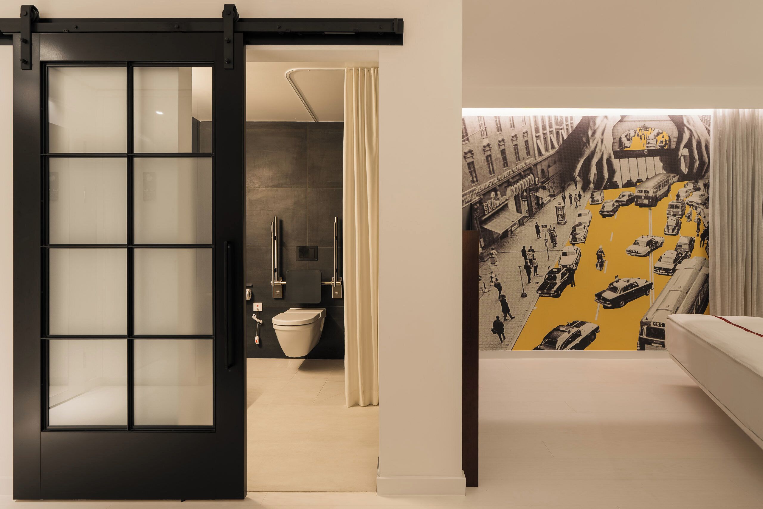 A modern bathroom with a toilet, sink, and shower.