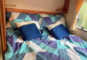Tabla de planchar con plancha y ropa de cama 