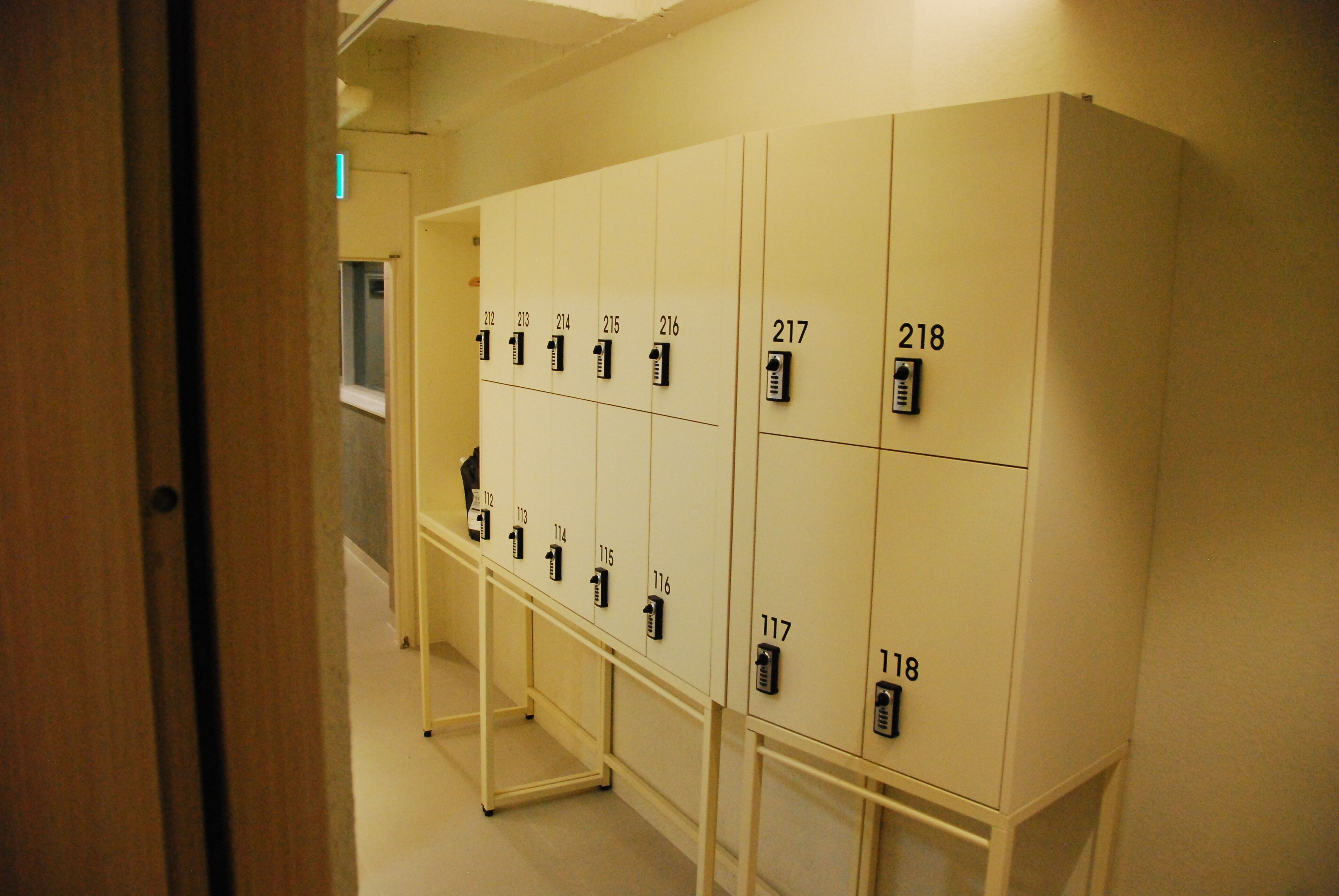 A row of numbered lockers in a hallway.