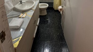 A bathroom with a toilet, sink, and shower area. - Hotel Boutique Qorikallpa (Cusco)