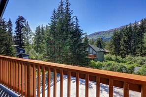 A wooden deck overlooking a forested area with a mountain in the background. - Family Friendly 4 Bedroom, Views, Walk to Resort (Anchorage)