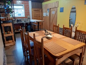 A dining area with a wooden table, chairs, and a decorative centerpiece.