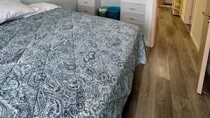A bedroom with a bed, a wardrobe, and an air conditioning unit. - Gated Luxury Fort George Retreat | Panoramic Port-of-Spain Views | Sleeps 8+ (Port of Spain)