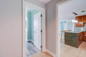 A modern kitchen with granite countertops, wooden cabinets, and pendant lighting. - That Driftwood Oasis (Biloxi)