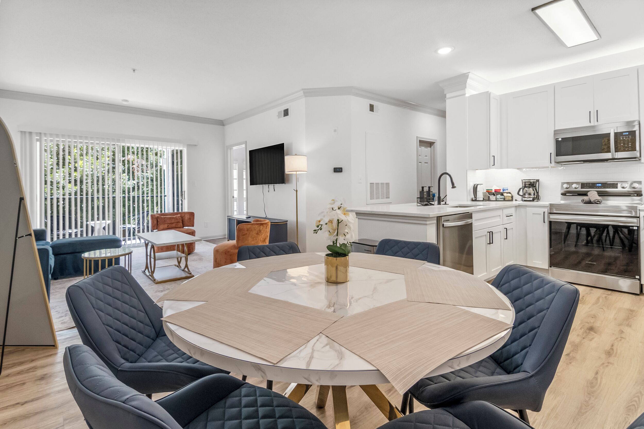 A modern kitchen with white cabinets, a built-in microwave, and a large oven.