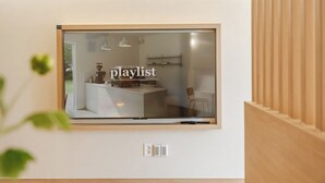 A modern kitchen with a built-in window, a coffee machine, and a minimalist design. - Tongyeong Dongpirang Stay.h (Tongyeong)