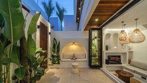 Un salón moderno con piscina, sofá y televisor mostrando el logotipo de Netflix.