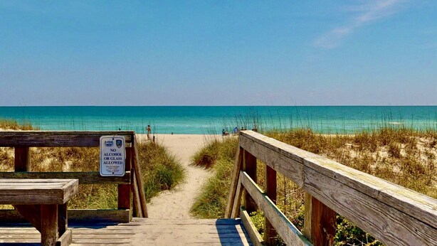 A wooden boardwalk leading to a beach with a sign prohibiting alcohol or glass. - Top Floor Ocean View Corner Condo w/ Balcony, Pool & Elevator – Near Beach & CB Lake (Carolina Beach)