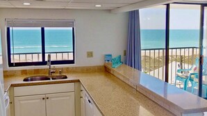 A kitchen with a view of the ocean, a sink, and a counter. - Top Floor Ocean View Corner Condo w/ Balcony, Pool & Elevator – Near Beach & CB Lake (Carolina Beach)