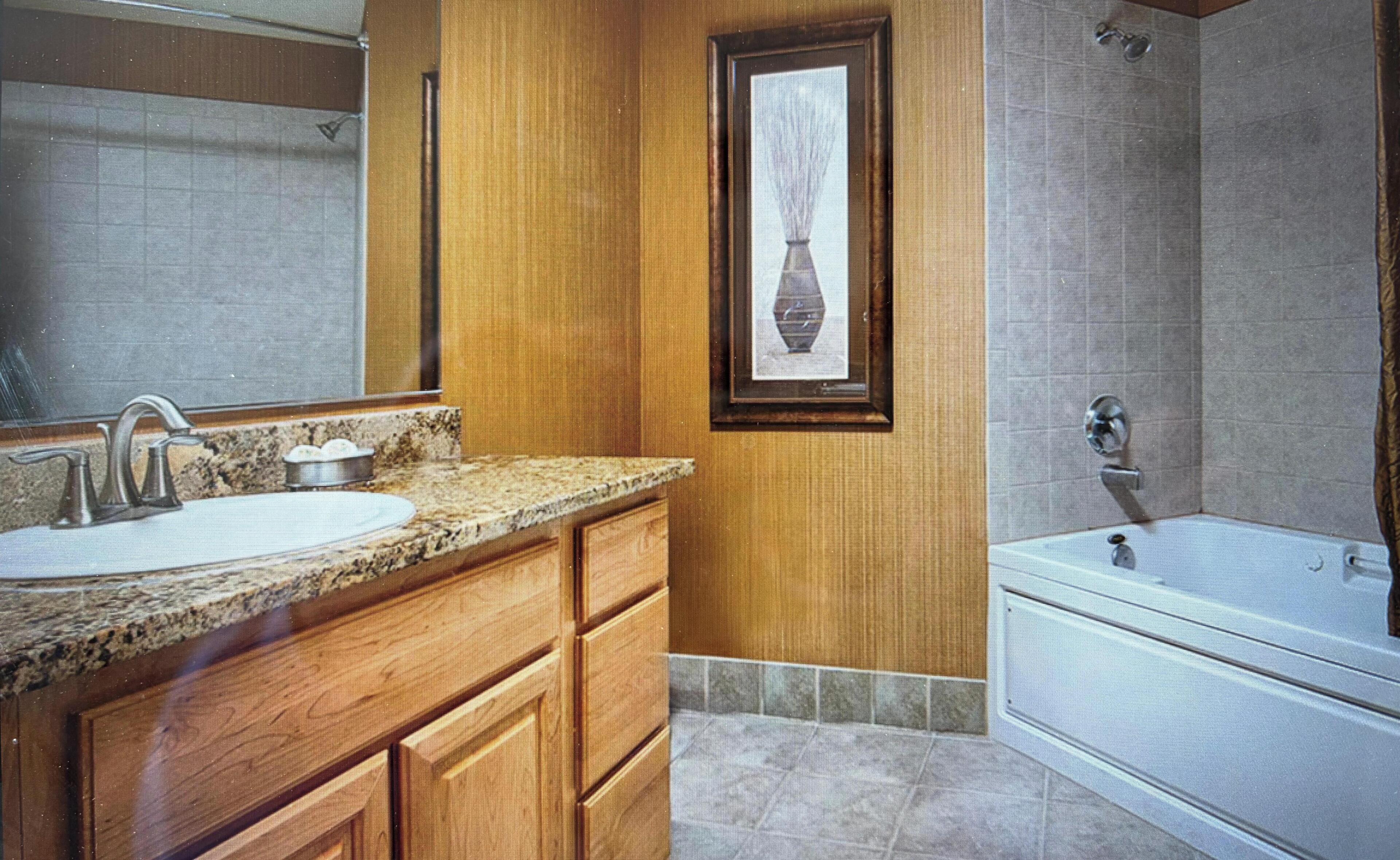 Un baño con lavabo, tocador y bañera.