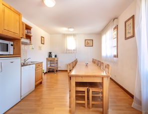 A compact kitchen with a microwave, refrigerator, and wooden cabinets. - Duplex for 12 Near Lake Annecy (Giez)