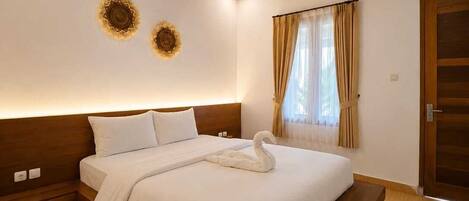 A modern bedroom with a wooden ceiling, a large bed with a swan-shaped pillow, and two wall-mounted decorative sunflowers.