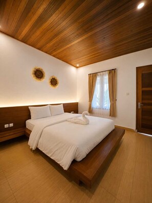 A modern bedroom with a wooden ceiling, a large bed with a swan-shaped pillow, and two wall-mounted decorative sunflowers.
