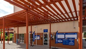 An outdoor covered area with a reception desk, informational signs, and a tiled floor. - Studio Apartment in Argeles-sur-mer (Argelès-sur-Mer)