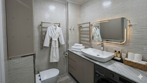 A modern bathroom with a large mirror, a sink, a toilet, and a shower. - Modern Apartment in Alfraganus  Rent Car & Moto (Tashkent)