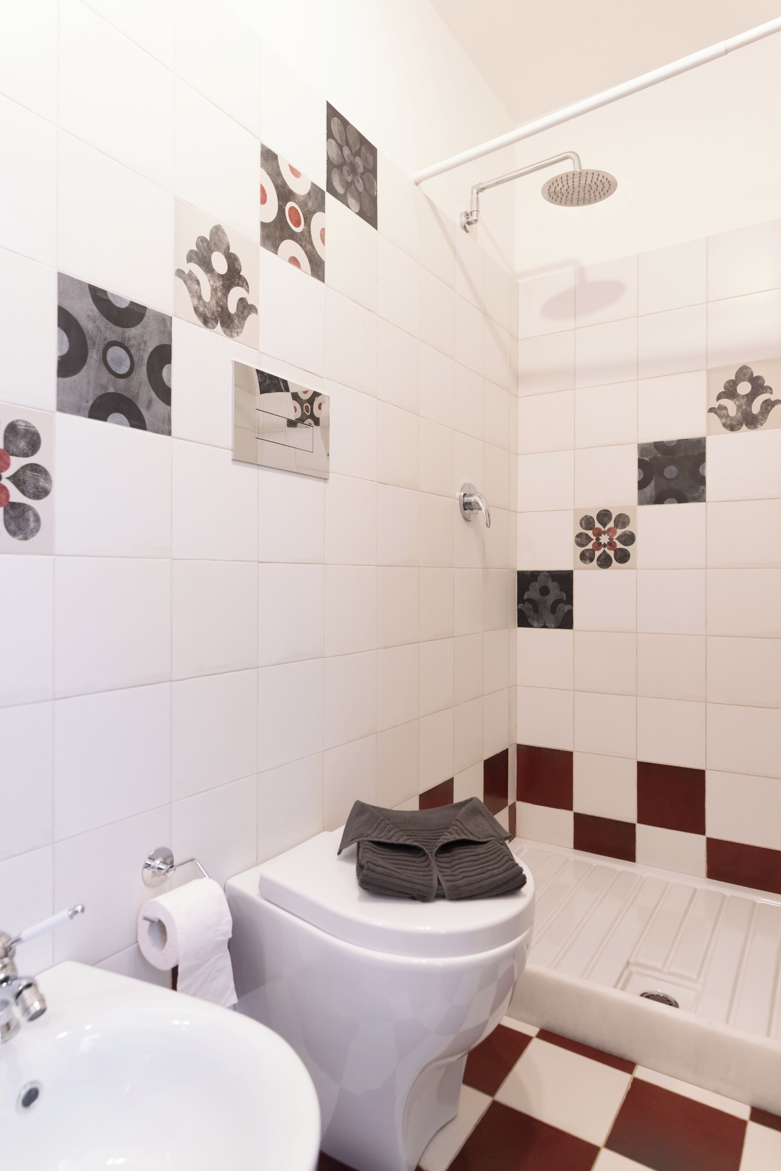 A bathroom with a toilet, sink, and shower.